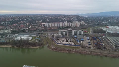 Bird's-eye view of Danube-side residences with roads, bus depot and bare trees Stock Footage 336468401