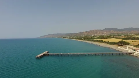 Bird's eye view with drone over wooden pier and beach Stock Footage 88164678