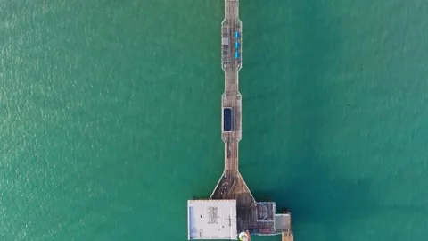 Birds Eye View Drone Pan of Sandown Pier, Isle of Wight, Turquoise Sea Stock-Footage 336996382