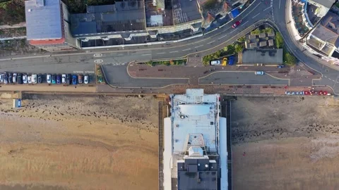 Birds Eye View Drone Pan of Sandown Pier, Isle of Wight, Turquoise Sea Stock Footage 336996526