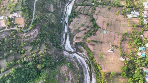 Bird's eye view of drought and dry riverbed next to farmland. Stockbeeldmateriaal 335638933