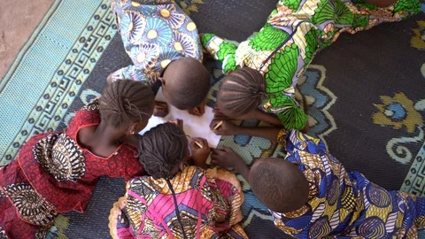 Birds Eye View On Five Small African Children Lying and Studying Stock Footage 122356316