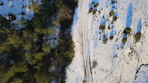 Bird's eye view flight over snowy field Stock Footage 196288766