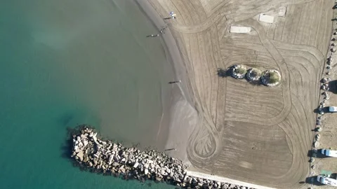 Birds eye view flying along our beach Stock Footage 232769644