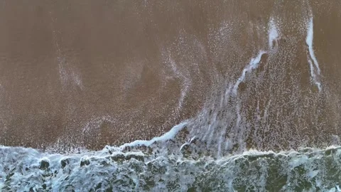 Birds-eye view of foamy ocean waves rolling onto Manasquan Beach Stock Footage 342253961