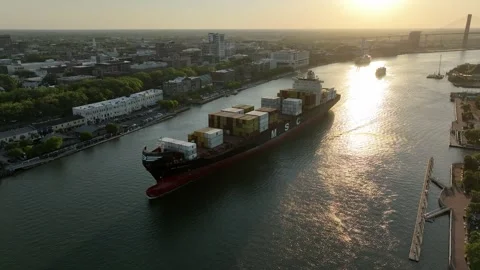 Bird's-eye view of a fully loaded cargo ship departing Savannah, Georgia at Видео 335258584