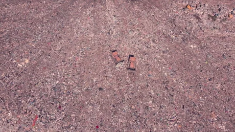 Bird's eye view of a garbage dump where machinery equals mountains of household Stock Footage 138298864