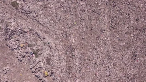 Bird's eye view of a garbage dump where machinery equals mountains of household Stock Footage 138300250