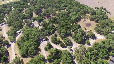 Bird's Eye View of Golf Carts Driving Through Woods to Skeet Shooting Station Video stock 75969897