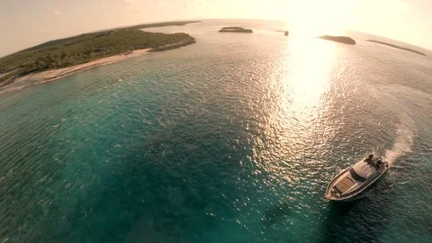 Birds eye view high above a luxury yacht and reef. Bahamas. Exumas. Shot in 4K. Video stock 77743366