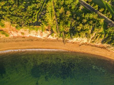 Bird's eye view looking down at wooden staircase leading to a beautiful ocean Stock Photos