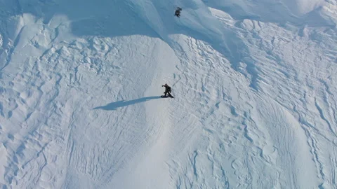 Bird's eye view of man walking through snow landscape on snowshoes Stock Footage 145890416