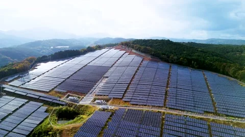 Bird's-Eye View of Modern Solar Panels Matrix in Green Field Stock Footage 336589604