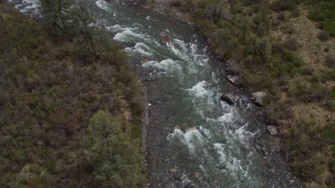 A bird's eye view of the mountain river's surface offers a vertical view. 4k Stock Footage 126720146