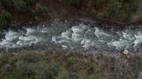 A bird's eye view of the mountain river's surface offers a vertical view. 4k Stock Footage 126720201