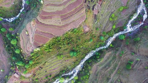 Birds eye view of mountain terraced step farming and flowing river in the N.. Stock Footage 338150563
