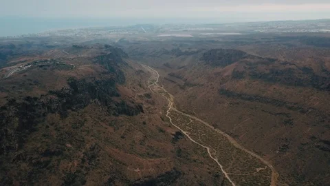 A bird's eye view of a mountain valley with a winding road. A beautiful mountain Stock Footage 95309441