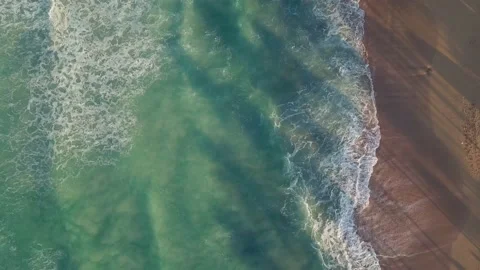Bird's eye view of the ocean beach waves turquoise spume copter vertically down Video stock 236191334