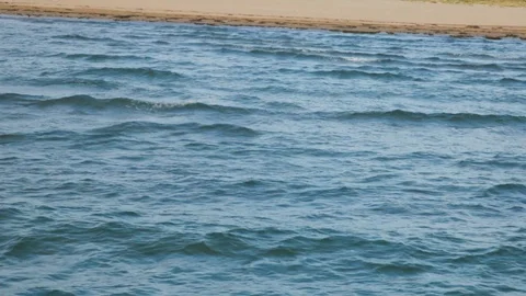Bird's eye view of ocean waves crashing against an empty beach Stock Footage 117410326