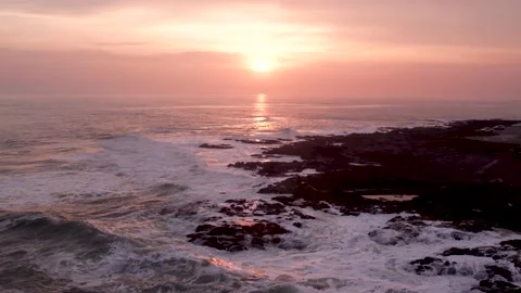 Bird's eye view of ocean waves crashing on rocks Stock Footage 220688666