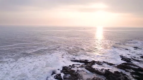Bird's eye view of ocean waves crashing on rocks Stock Footage 222047715
