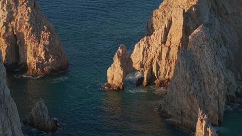 Bird's-eye view from orbit of the isolated arch at Cabo San Lucas, with the Stock Footage 334833453