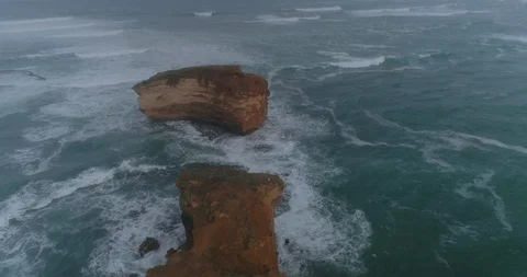 A birds eye view over rocks and the Great Ocean Road with birds. Victoria. Stock Footage 97314488