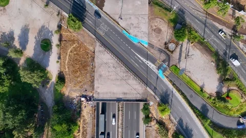 Bird's eye view over urban highway underpass with bus lane overpass bridge Stock Footage 336268043