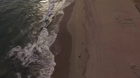 Bird's Eye view pan to sunset beach aerial Stock Footage 79972478