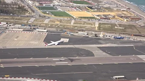 Bird's-eye view of a plane taking off at Gibraltar airport, HD Stock Footage