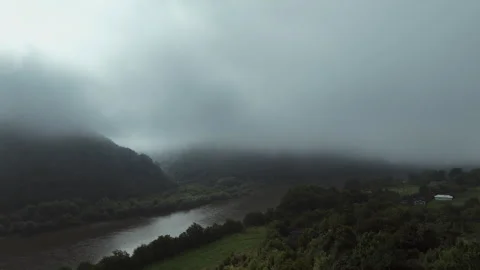 Bird's eye view of the river canyon through the fog and sunlight Stock Footage 253224600