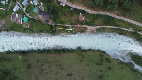 Bird’s-eye view of a riverbed flowing gently past Pahalgam village. Stock Footage 310656191