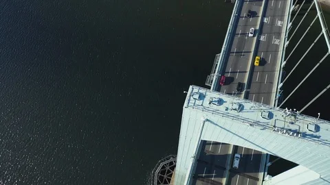 Birds-eye view rotating dizzying aerial top of bridge Stock Footage