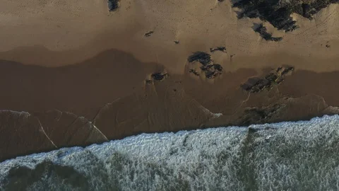 Birds Eye View Of Sandy Empty Beach And Ocean Waves Stock Footage 128844819