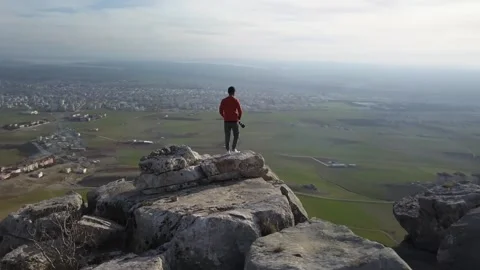 Bird's eye view scene from mountain to city and photographer Stock Footage 240495904