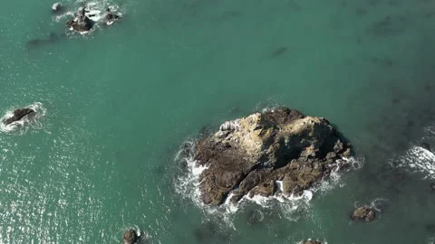 Bird's Eye View Of Sea Stack With Birds At Daytime - aerial, top down Video stock 151346573