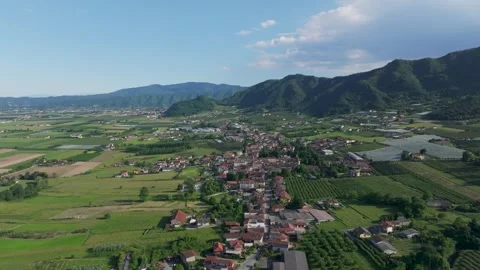 Birds eye view showing human settlement in beautiful valley on bright sunny day. Stock Footage 321669741