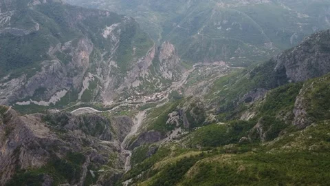 Bird's eye view of a small settlement in a mountain valley Stock Footage 167685559