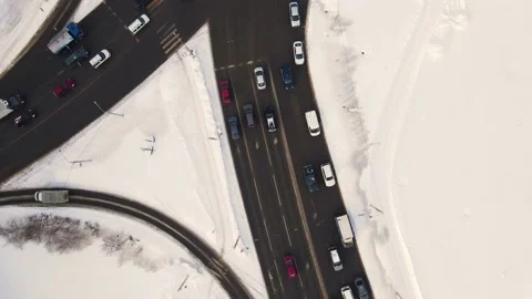 Bird's eye view of a snowy city crossroads with cars in winter. Stock Footage 224831769