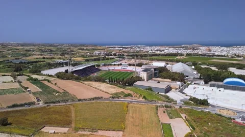 Bird's-eye view of Ta' Qali's national stadium amid parkland and fields Stock Footage 336468805