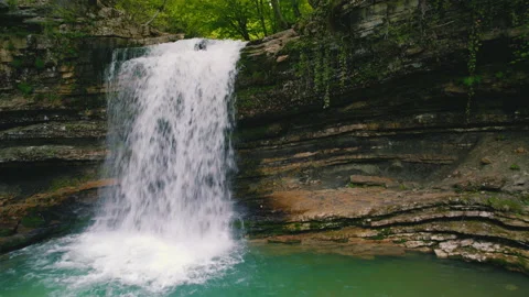 Birds-eye view of a tiny waterfall and large stones covered with green moss Stock Footage 202191184
