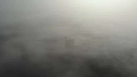 Birds eye view on tower crane in fog standing next to residential building Stock Footage 123435226