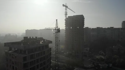 Birds eye view on tower crane in fog standing next to residential building Stock Footage 123436009