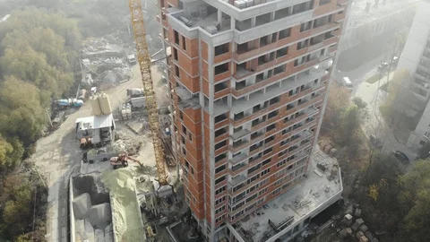 Birds eye view on tower crane in fog standing next to residential building Stock Footage 123436142