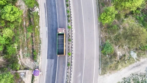 Bird's eye view tracking freight truck loaded with construction material. Stockbeeldmateriaal 335643431