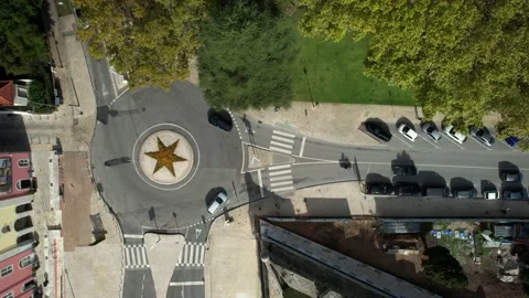 Bird's eye view of a traffic roundabout with cyclists and cars passing Stock Footage 219738630