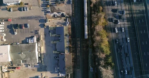 A birds-eye view of a train and traffic moving along parallel lines Stock Footage 92816873