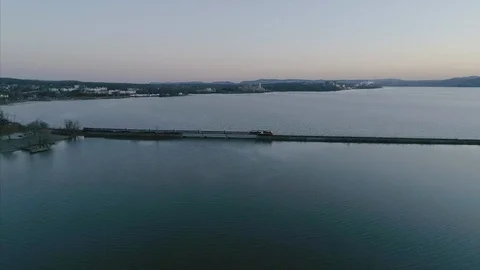 Birds Eye View of Train Passing Over the Hudson River at Sunset Stock Footage 94657566