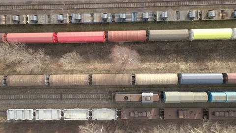 Birds eye view of Train slowing riding between other cargo trains Stock Footage 219745197