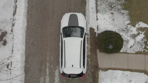 Birds eye view from tree branch, none recognizable person getting into car Stock Footage 125220952